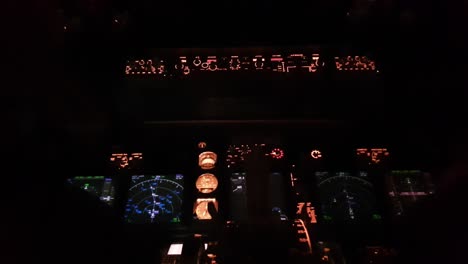 Cockpit-of-airplane-with-illuminated-instruments-at-night
