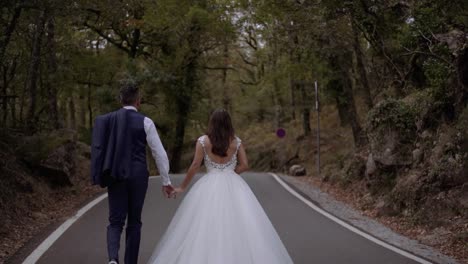 Bride-and-Groom-walking-on-forest-road-in-slow-motion-sideways-slide