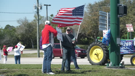 Donald-Trump-Supporters-standing-on-a-street-corner-with-signs-and-flags-showing-their-support-for-Donald-Trump-on-a-sunny-day-in-south-Florida