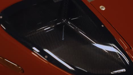 Dolly-Shot-of-a-Carbon-Fiber-Headlight-on-Red-Ford-GT3-Super-Car