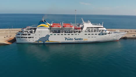 Aerial-dolly-shot-vessel-Lobo-Marinho-crossing-islands,-Porto-santo-island