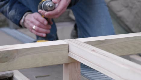 A-man-swaps-drill-bits-and-countersinks-some-wood
