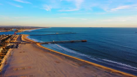Saturated-slow-aerial-shot-flying-towards-the-Seal-Beach-Pier
