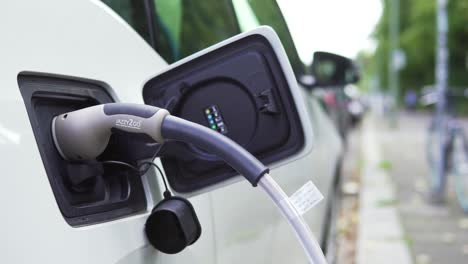 Slow-Motion-of-Charging-Cable-Plugged-into-Electric-Vehicle,-Close-Up