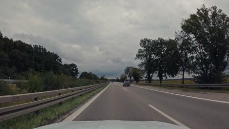 Driving-with-a-car-at-the-motorway-in-germany-changing-from-fast-lane-to-the-right-one,-after-overtaking-another-car-in-real-time