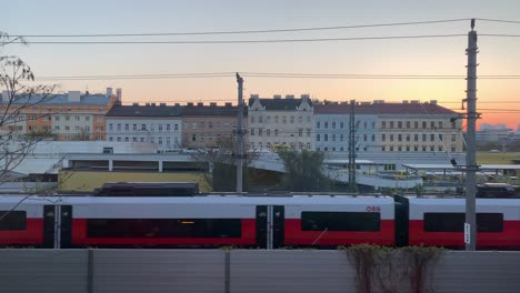 Various-scenes-of-commuter-trains-passing-in-front-of-buildings-in-the-city-of-Vienna,-Austria