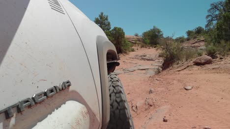 POV-of-Toyota-Tacoma-driving-off-road-on-desert-rocky-sand-track