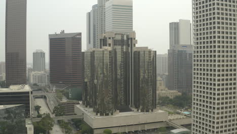 Aerial-pull-in-on-the-Westin-Bonaventure-Hotel-in-a-smoke-filled-downtown-Los-Angeles