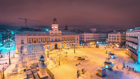 Night-to-day-timelapse-of-the-Puerta-del-Sol-in-Madrid,-Spain-covered-by-snow-during-big-snowstorm-in-Madrid,-january-2021
