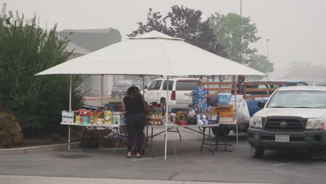 Volunteers-distribute-items-in-smoky-conditions-to-evacuees-from-California,-Creek-Fire