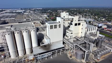 Aerial-of-beer-plant---Anheuser-Busch-Beer-manufacturing-factory,-in-Los-Angeles,-California,-USA---tracking,-drone-shot