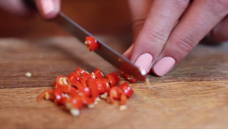 White-Female-Chef-Chopping-Chilli-Pepper