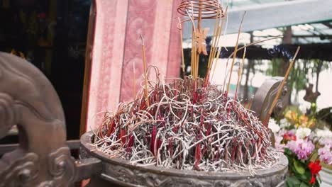 Aromatic-Steams-From-Burning-Incense-Sticks-In-Front-Of-An-Altar-At-Buddhist-Temple-In-Tam-Coc,-Vietnam