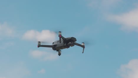 Drone-In-Flight-Against-The-Blurry-Sky-Background---low-angle-full-shot