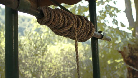 Close-up-of-Vintage-Rope-and-Drawing-Water-from-Old-Well-with-Iron-Bucket-in-slowmo