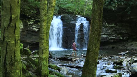 A-fisherman-below-Seneca-Falls,-a-large-waterfall-located-along-Seneca-Creek,-within-the-Spruce-Knob-Seneca-Rocks-National-Recreation-Area-in-West-Virginia
