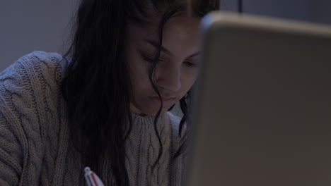 Female-Teenage-Student-Doing-Homework-Using-Laptop