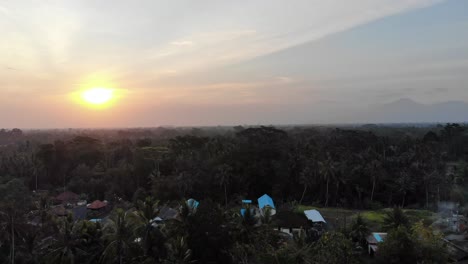 Drone-shot-of-the-sun-setting-in-Bali,-Indonesia