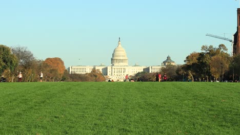 People-Walking-And-Having-Fun-On-Green-Lawn-With-United-States-Capitol-In-Background-During-Autumn-In-Washington,-USA