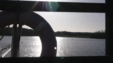 View-of-lake-through-safety-buoy-and-rope-medium-shot