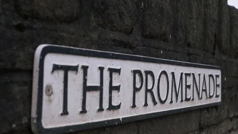 Promenade-street-sign-on-a-wall-close-up-panning-shot