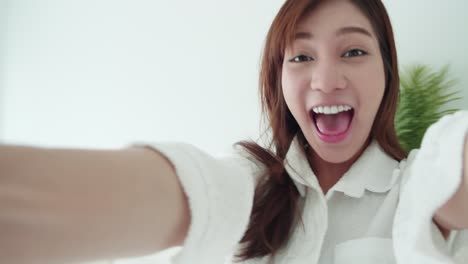 Tracking-in-Asian-woman-with-a-white-shirt-spins-frottage-feel-good-with-a-selfie-video