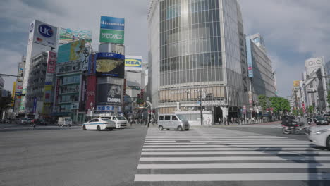Tsutaya-Building-With-Traffic-In-Foreground-Driving-At-Shibuya-Crossing-During-Pandemic-In-Tokyo,-Japan