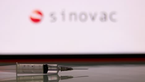 Syringe-Injection-placed-in-front-of-the-Sinovac-logo