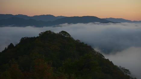 Takeda-Castle-Ruins,-Wide-Pan-Over-Mist-Covered-Valley-Before-Sunrise