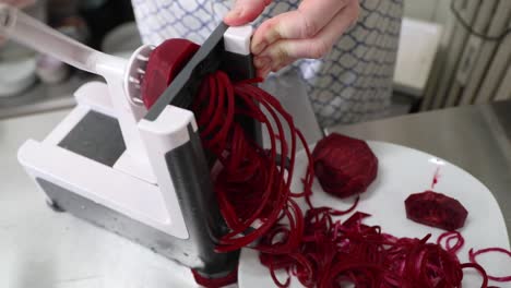 Shredding-Beetroot-In-The-Kitchen-With-A-Rotary-Shredder---close-up,-slow-motion