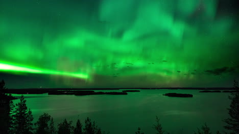 Timelapse-of-aurora-borealis,-a-magnetic-solar-phenomenon,-above-lake-Hoytianen,-on-a-cold-autumn-night,-in-Huhmari,-North-Karelia,-Finland