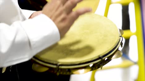 Tambourine-player-at-concert,-flat-plane,-video,-closeup,-side-angle