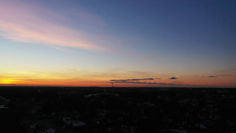 A-drone-shot-over-a-suburban-neighborhood-during-a-golden-sunrise