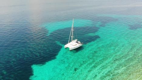 Aerial-drone-shot-of-a-catamaran-on-the-crystal-clear-sea-in-Croatia