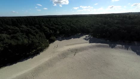 Aerial-footage-of-people-on-a-sand-hill