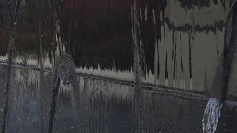Water-falling-off-of-a-fountain-wall-into-water-in-120-fps-slow-motion