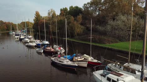 Reveal-shot-of-un-manned-sailing-boats-on-canal
