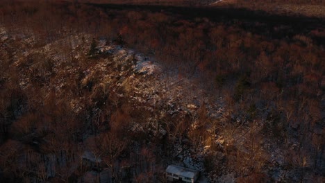 Drone-fly-to-snowy-ridge-forest-at-sunrise