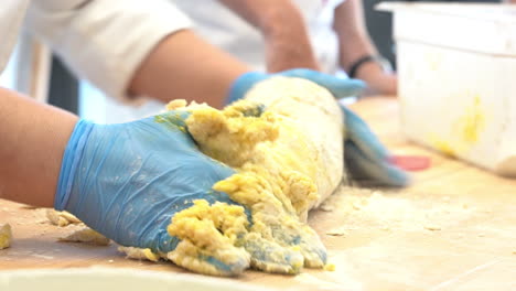 human-hands-with-latex-glovs-modelling-a-dough-of-a-typical-type-of-italian-pasta-made-flour-eggs-and-water