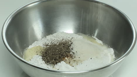 Adding-Salt-and-Pepper-on-Egg-and-Flour