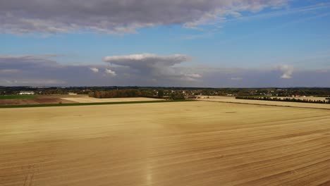 Aerial-view-of-golden-fields-with-brown-mold-close-to-Sejerøbugten-in-Odsherred