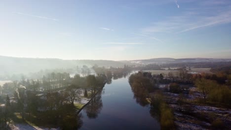 Misty-drone-clip-of-the-river-thames-on-a-winters-morning-with-blue-skys-and-calm-water