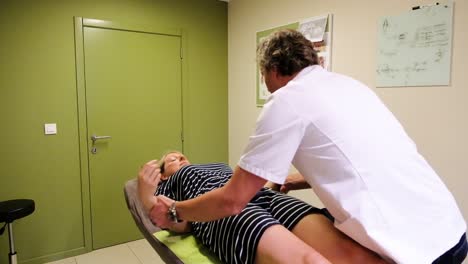 Osteopath-making-assessment-for-a-female-patient
