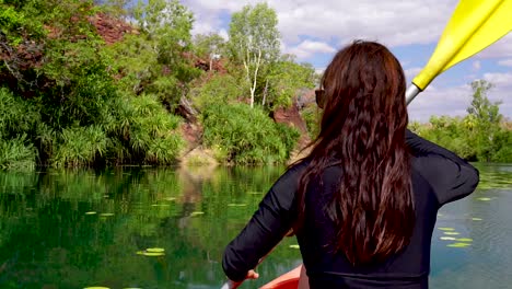 Girl-canoeing-down-scenic-river-in-an-oasis-in-the-Australian-Outback