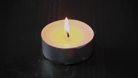 Time-lapse-of-a-tea-light-candle-lighting-and-melting-the-wax