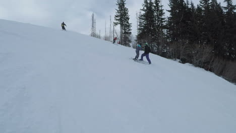 Passing-couple-on-white-ski-slopes-learning-to-balance-on-skis