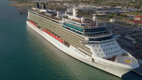 Aerial-close-up-view-of-the-side-on-the-cruise-ship-while-in-dock-with-the-sun-shining-on-it