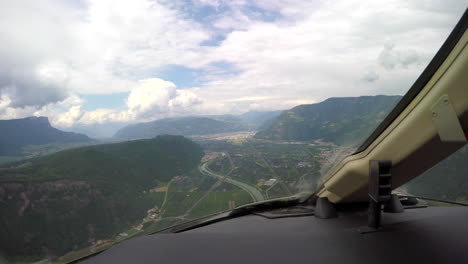 View-from-the-cockpit-of-a-corporate-jet-circling-for-landing-in-a-small-valley-in-the-Italian-Alps