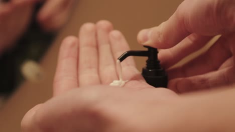 Hand-cream-is-squeezed-out-of-a-pump