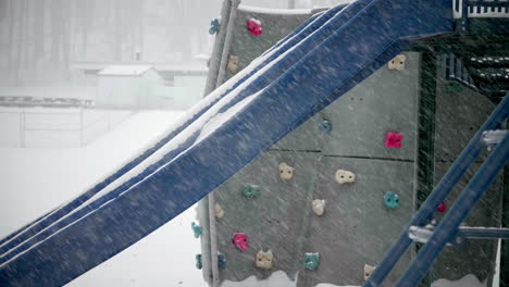 Slide-and-Equipment-in-Playground-During-Snow-Storm-TILT-UP-SLOW-MOTION